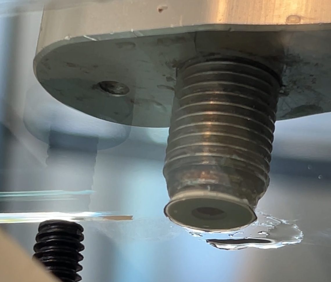 Rock chip repair tool sits on top of rock chip damage as resin sets into chip